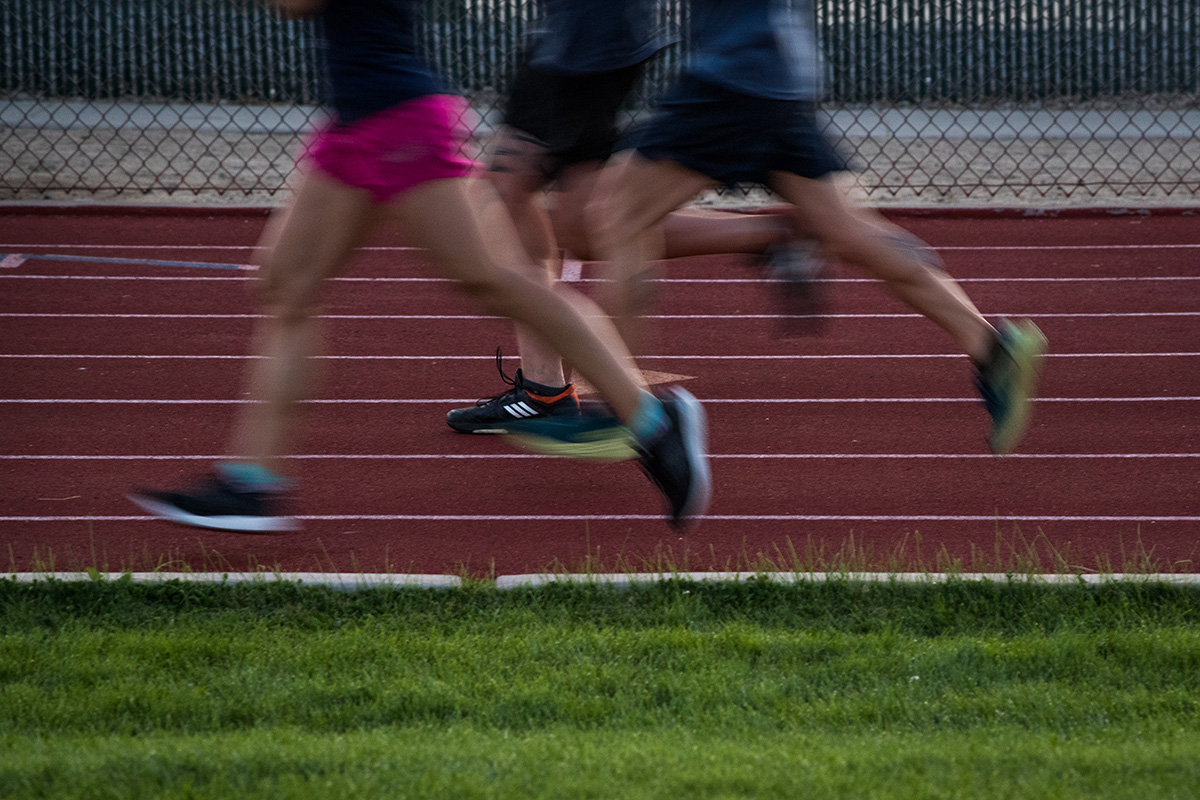 Group of runners legs and knees on track to help illustrate runner's knee